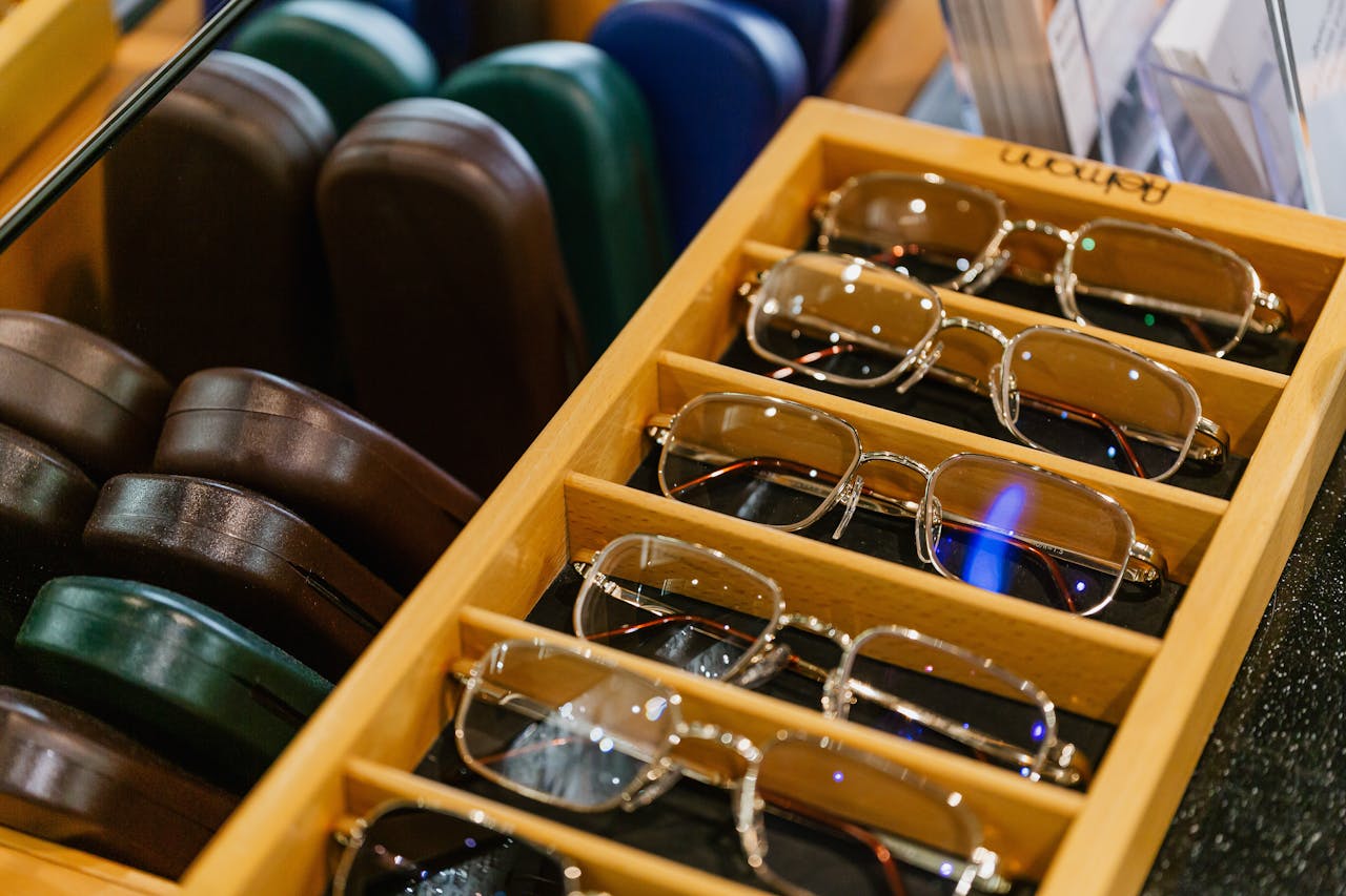 Mastering the First Impression: Your intriguing post title goes here Neatly arranged eyeglasses in a stylish wooden display case at an opticians shop.
